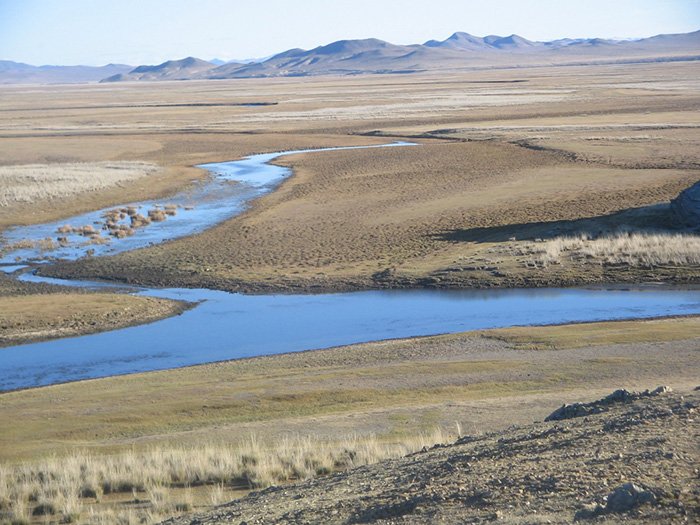 A river winds through the centre of the Undurshireet in Mongolia. 