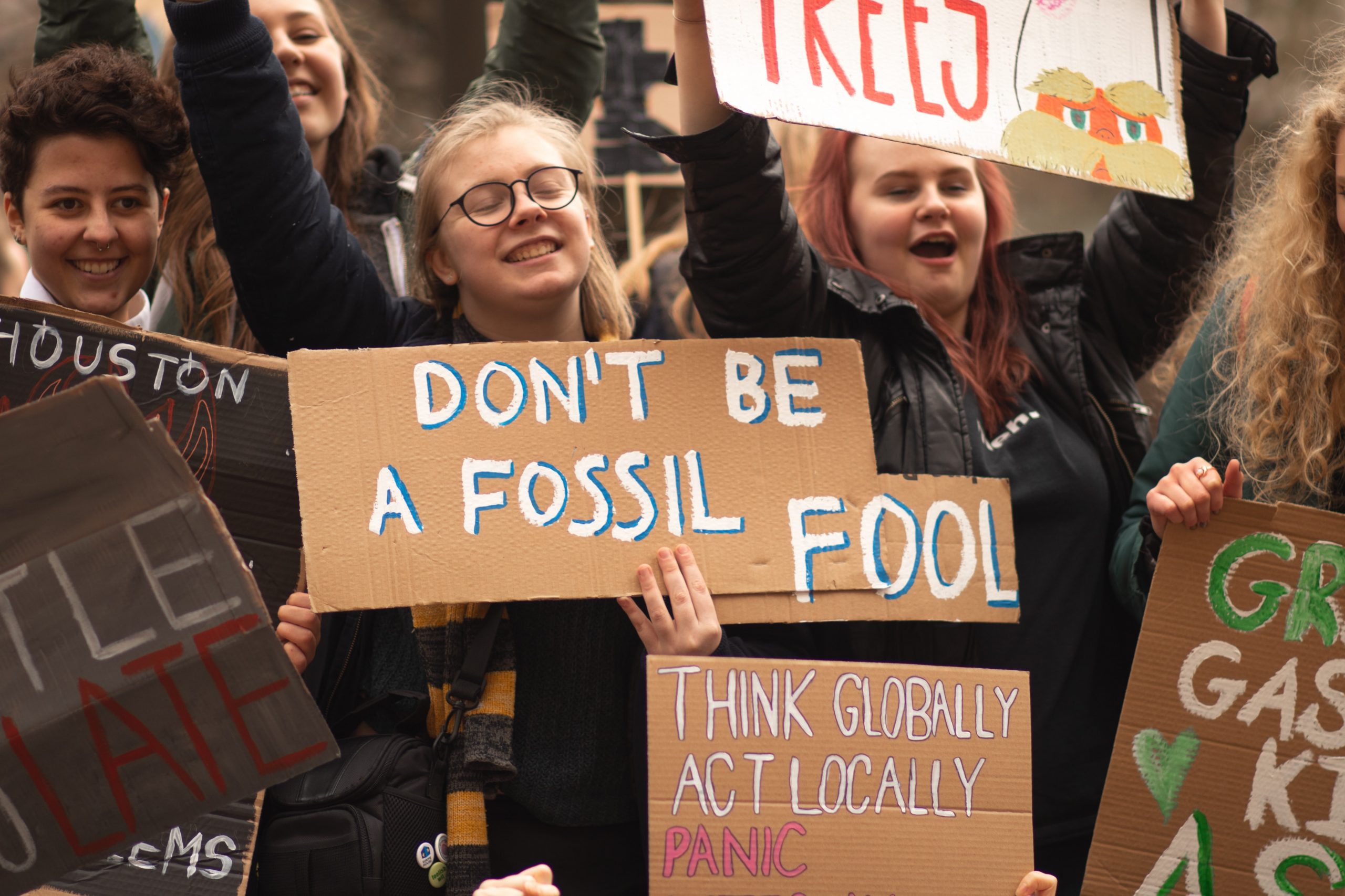 Photo by Callum Shaw on Unsplash Climate action posters held up by climate activists